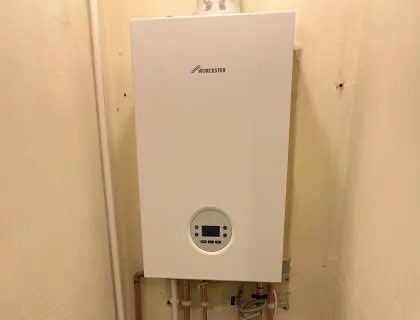 Combi boiler fitted in a hallway alcove after a back boiler removal in Liverpool